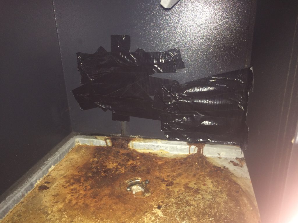 Rusted condensate drain in poorly-installed MVHR system