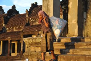 Old lady collects plastic bottles in Indonesia