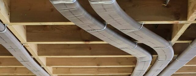Flat 51mm semi-rigid ducting running pinned neatly to ceiling joists to prevent loss of room height