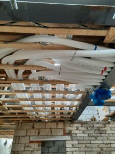 90mm semi-rigid ducting in webbed joists returning to 12-port steel manifold of MVHR system