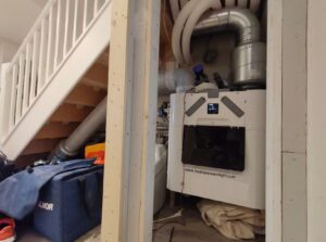 Retrofit MVHR system installed by Heat, Space and Light Ltd under stairs