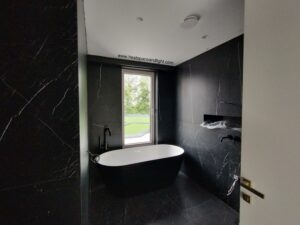 MVHR extract valve in all black marble bathroom